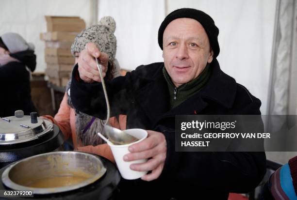 French chef Thierry Marx serves soup during an event marking the 10th anniversary of the death of Abbe Pierre, founder of the Emmaus solidarity...