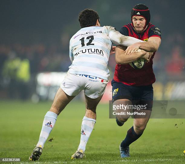 Tyler Bleyendaal of Munster tackled by Etienne Dussarte of Racing during the European Rugby Champions Cup Round 6 match between Munster Rugby and...