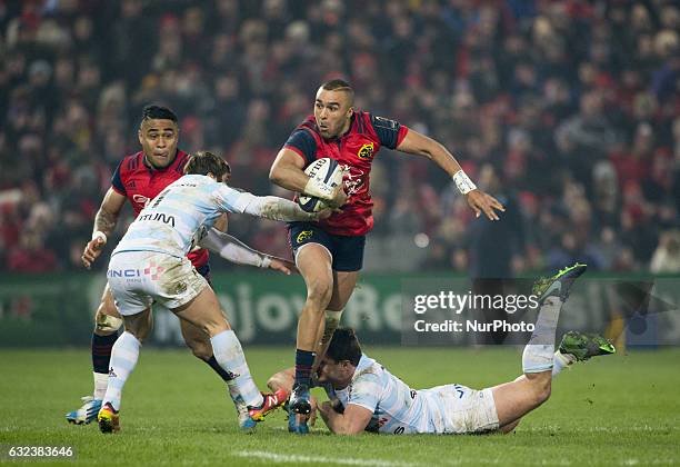 Simon Zebo of Munster tackled by Henry Chavancy and Marc Anderu of Racing during the European Rugby Champions Cup Round 6 match between Munster Rugby...