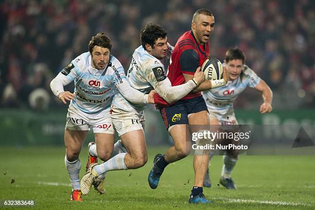 Simon Zebo of Munster tackled by Etienne Dussartre of Racing during the European Rugby Champions Cup Round 6 match between Munster Rugby and Racing...