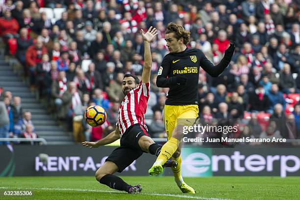 Antoine Griezmann of Atletico Madrid competes for the ball with Mikel Balenziaga of Athletic Club during the La Liga match between Athletic Club...