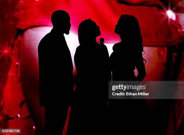 Adult film actor Isiah Maxwell, adult film actress Karlee Grey and adult film actress/director jessica drake are silhouetted as they present an award...