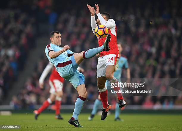 Dean Marney of Burnley and Francis Coquelin of Arsneal compete for the ball during the Premier League match between Arsenal and Burnley at the...