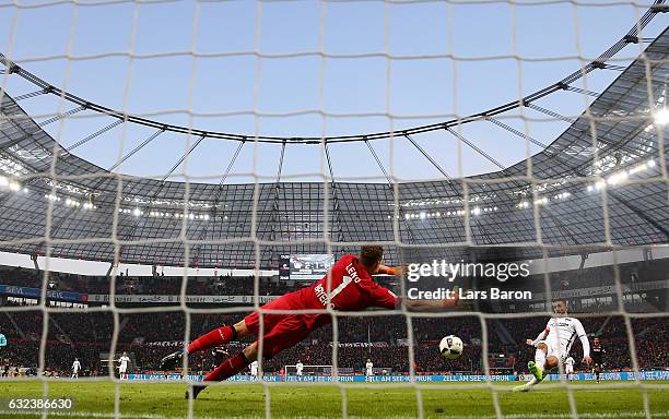 Bernd Leno of Leverkusen saves a shot from Vedad Ibisevic of Berlin during the Bundesliga match between Bayer 04 Leverkusen and Hertha BSC at...