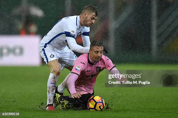 Thiago Cionek of Palermo is challenged by Davide Santon of Internazionale Milano during the Serie A match between US Citta di Palermo and FC...