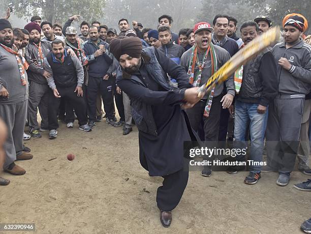 Navjot Singh Sidhu, Congress candidate from Amritsar East constituency, playing cricket with city youngsters during a poll campaign at famous Ram...