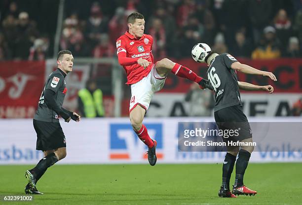 Gaetan Bussmann of Mainz is challenged by Pawel Olkowski of Koeln during the Bundesliga match between 1. FSV Mainz 05 and 1. FC Koeln at Opel Arena...