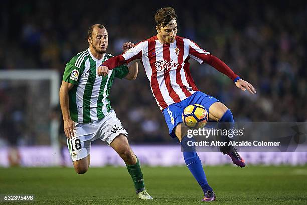 Fernando Gabriel Amorebieta of Sporting de Gijon being followed by Roman Zozulya of Real Betis Balompie during La Liga match between Real Betis...