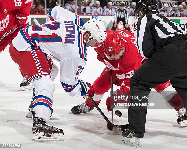 Derek Stepan of the New York Rangers faces off against Frans Nielsen of the Detroit Red Wings during an NHL game at Joe Louis Arena on January 22,...
