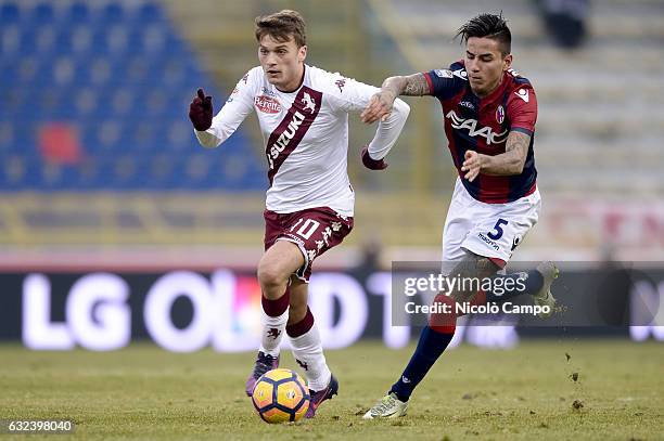 Adem Ljajic of Torino FC and Erick of Bologna FC compete for the ball Pulgar during the Serie A football match between Bologna FC and Torino FC....