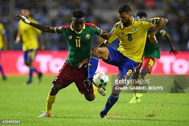 Cameroon's forward Edgar Salli challenges Gabon's defender Lloyd Palun during the 2017 Africa Cup of Nations group A football match between Cameroon...