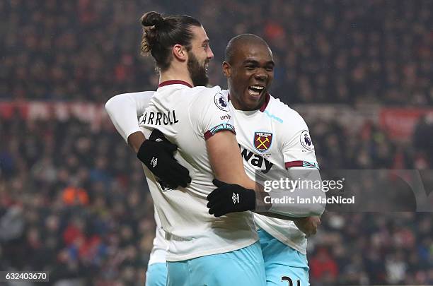 Andy Carroll of West Ham United celebrates after scoring his first goal with Angelo Ogbonna Obinze during the Premier League match between...