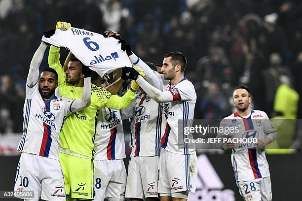 Lyon players celebrate and pay tribute to Gueida Fofana after Lyon's French forward Mathieu Valbuena scored a goal during the French L1 football...