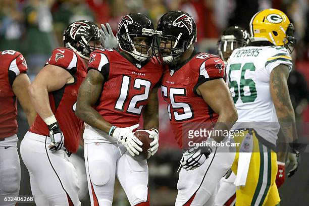 Mohamed Sanu of the Atlanta Falcons celebrates scoring a first quarter 2-yard touchdown with Chris Chester against the Green Bay Packers in the NFC...