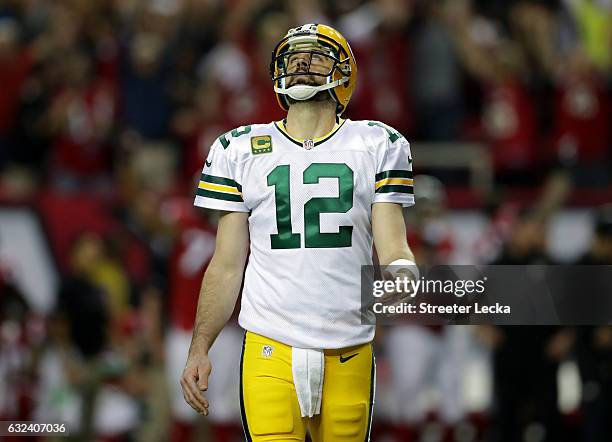 Aaron Rodgers of the Green Bay Packers looks on after a turnover in the second quarter against the Atlanta Falcons in the NFC Championship Game at...