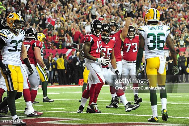 Mohamed Sanu of the Atlanta Falcons celebrates scoring a first quarter 2-yard touchdown with Chris Chester against the Green Bay Packers in the NFC...
