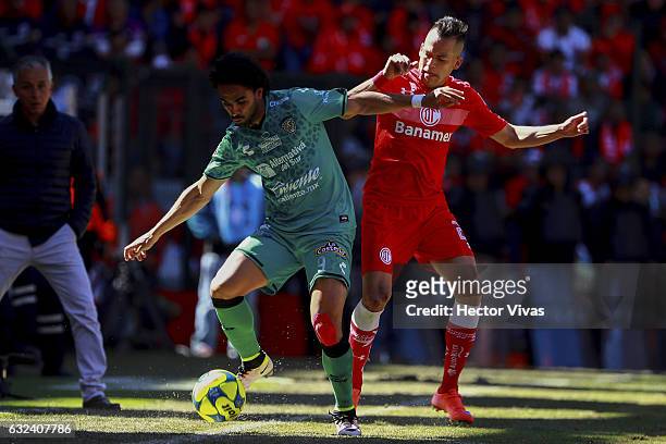 Rodrigo Salinas of Toluca struggles for the ball with Enrique Esqueda of Chiapas during a match between Toluca and Chiapas as part of the Clausura...
