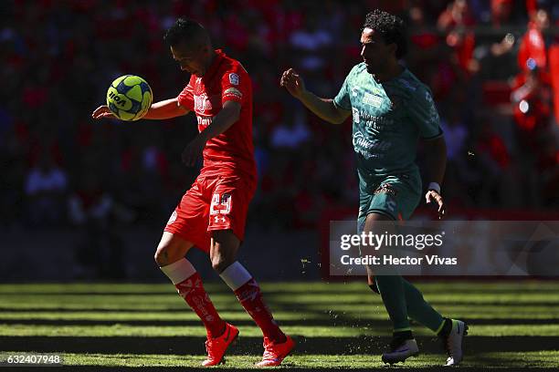 Rodrigo Salinas of Toluca struggles for the ball with Enrique Esqueda of Chiapas during a match between Toluca and Chiapas as part of the Clausura...