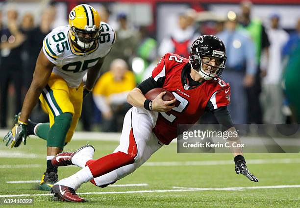 Matt Ryan of the Atlanta Falcons runs with the ball in the second quarter against Datone Jones of the Green Bay Packers in the NFC Championship Game...