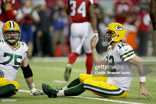 Aaron Rodgers of the Green Bay Packers reacts after a play in the first half against the Atlanta Falcons in the NFC Championship Game at the Georgia...