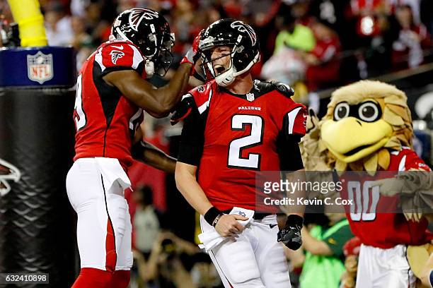 Matt Ryan of the Atlanta Falcons celebrates with Aldrick Robinson after a 14 yard touchdown run in the second quarter against the Green Bay Packers...