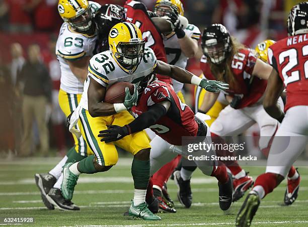 Christine Michael of the Green Bay Packers is wrapped up by Deion Jones of the Atlanta Falcons during the third quarter in the NFC Championship Game...