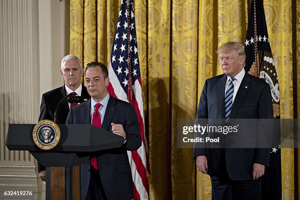 Reince Priebus, White House chief of staff, speaks as U.S. President Donald Trump and U.S. Vice President Mike Pence listen during a swearing in...