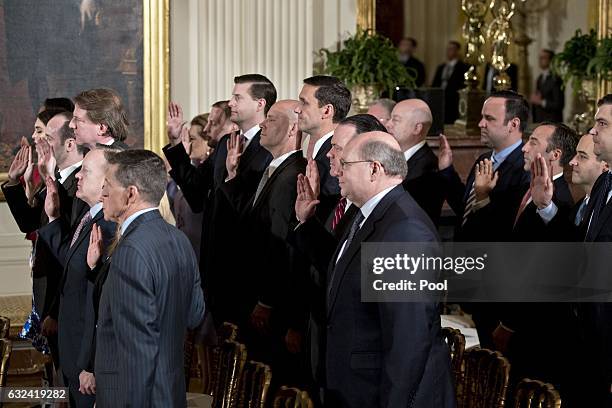 White House senior staff members are sworn in by U.S. Vice President Mike Penceduring a ceremony in the East Room of the White House on January 22,...