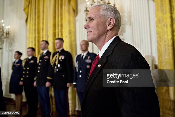 Vice President Mike Pence arrives to a swearing in ceremony of White House senior staff in the East Room of the White House on January 22, 2017 in...