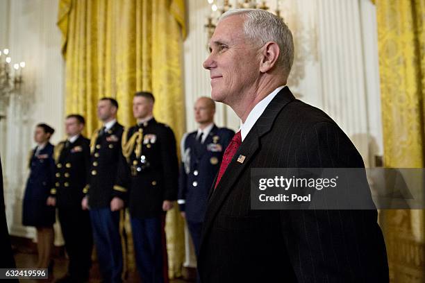 Vice President Mike Pence arrives to a swearing in ceremony of White House senior staff in the East Room of the White House on January 22, 2017 in...