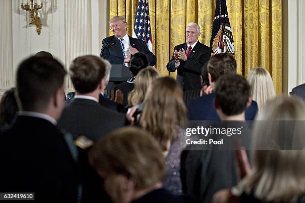 President Donald Trump and U.S. Vice President Mike Pence arrive to a swearing in ceremony of White House senior staff in the East Room of the White...