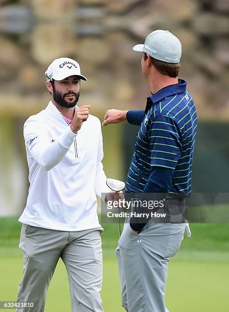 Hudson Swafford fist pumps with Adam Hadwin of Canada on the 17th hole during the final round of the CareerBuilder Challenge in partnership with The...