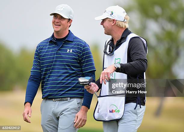 Hudson Swafford talks with caddie D.J. Nelson on the 16th hole during the final round of the CareerBuilder Challenge in partnership with The Clinton...