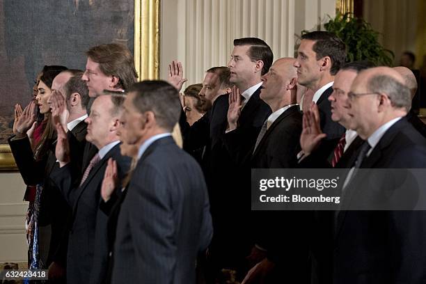 White House senior staff members are sworn in by U.S. Vice President Mike Pence, not pictured, during a ceremony in the East Room of the White House...