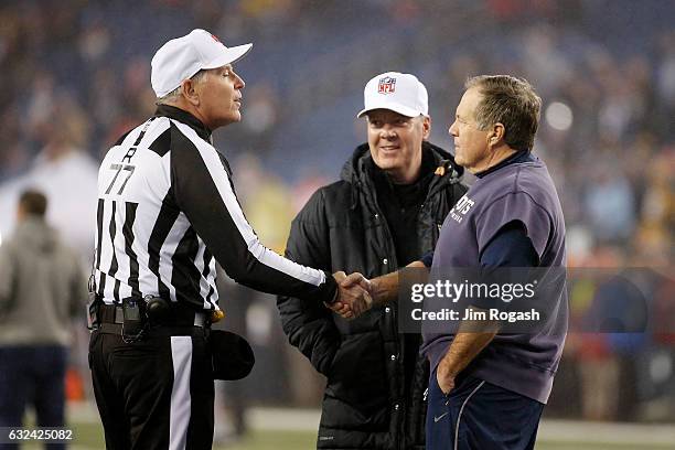 Referee Terry McAulay shakes hands with head coach Bill Belichick of the New England Patriots prior to the AFC Championship Game against the...