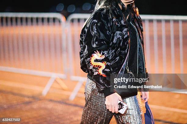 Guest is wearing a black bomber jacket with a printed yellow dragon on the sleeve, outside the Thom Browne show, during Paris Fashion Week Menswear...