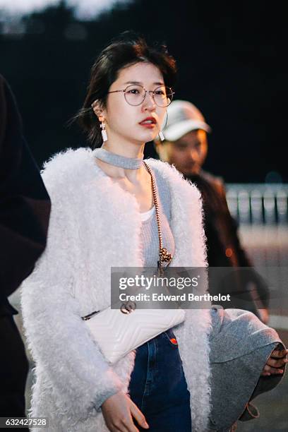 Guest is wearing a white faux fur coat, a gray choker, and a white Gucci bag, outside the Thom Browne show, during Paris Fashion Week Menswear...
