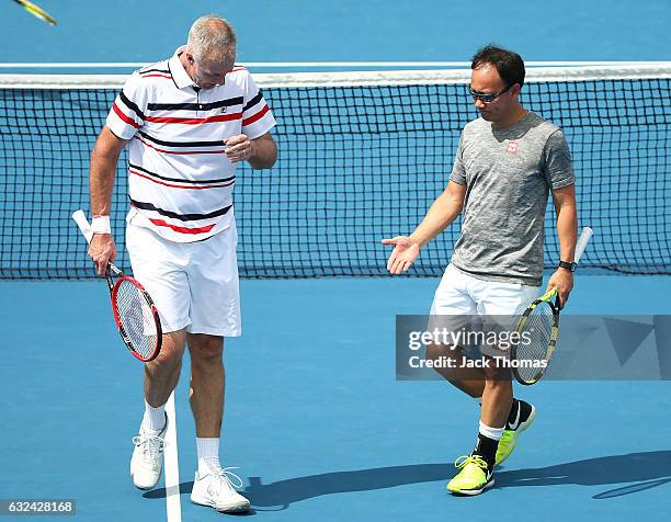 Jacco Eltingh and Paul Haarhuis of the Netherlands compete in the first round legends match against Michael Chang and Todd Martin of the United...