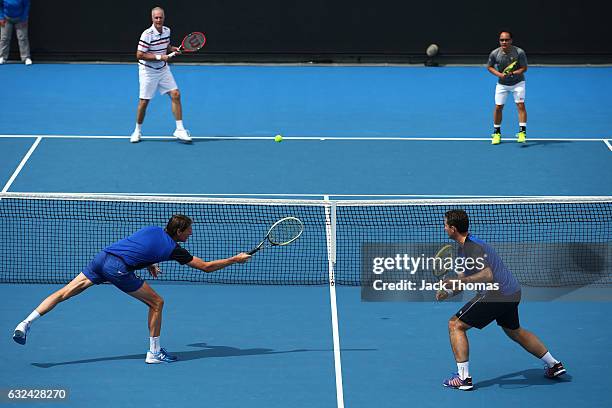 Jacco Eltingh and Paul Haarhuis of the Netherlands compete in the first round legends match against Michael Chang and Todd Martin of the United...