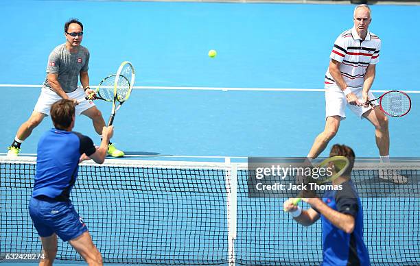 Jacco Eltingh and Paul Haarhuis of the Netherlands compete in the first round legends match against Michael Chang and Todd Martin of the United...