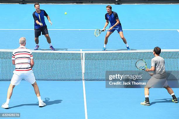 Jacco Eltingh and Paul Haarhuis of the Netherlands compete in the first round legends match against Michael Chang and Todd Martin of the United...