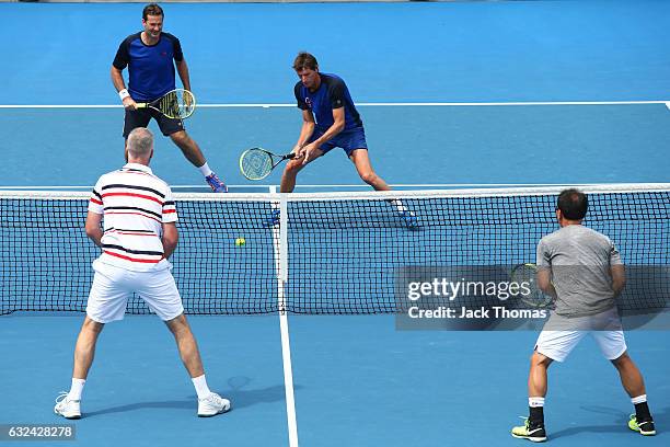 Jacco Eltingh and Paul Haarhuis of the Netherlands compete in the first round legends match against Michael Chang and Todd Martin of the United...
