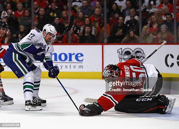 Corey Crawford of the Chicago Blackhawks stops a shot by Daniel Sedin of the Vancouver Canucks at the United Center on January 22, 2017 in Chicago,...