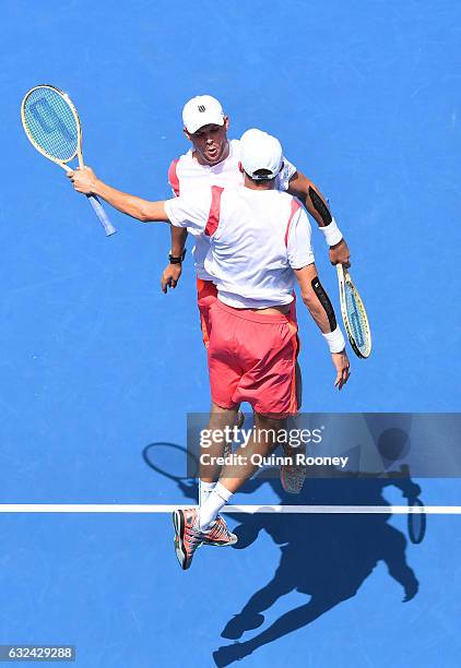 Bob Bryan and Mike Bryan of the United States celebrate winning their third round match against Brian Baker of the United States and Nikola Mektic of...