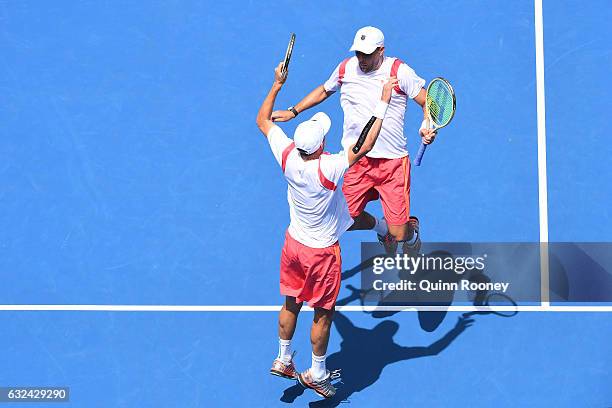 Bob Bryan and Mike Bryan of the United States celebrate winning their third round match against Brian Baker of the United States and Nikola Mektic of...