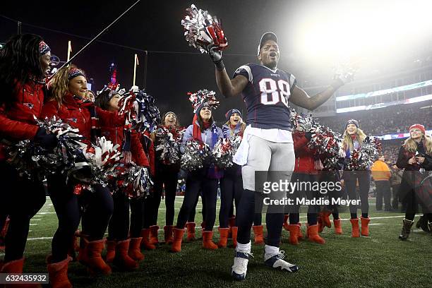 Martellus Bennett of the New England Patriots celebrates with cheerleaders after defeating the Pittsburgh Steelers 36-17 to win the AFC Championship...
