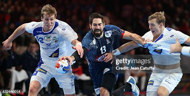 Nikola Karabatic of France in action between Olafur Andres Gudmundsson and Janus Dadi Smarason of Iceland during the 25th IHF Men's World...