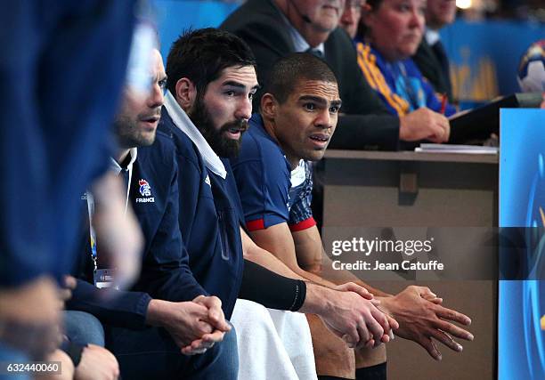 Nikola Karabatic and Daniel Narcisse of France look on from the bench during the 25th IHF Men's World Championship 2017 Round of 16 match between...
