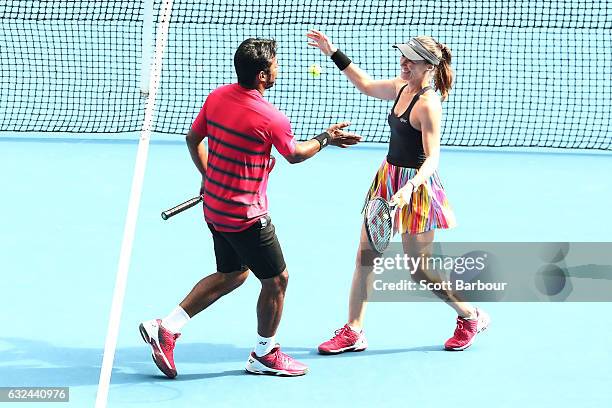 Martina Hingis of Switzerland and Leander Paes of India celebrate winning their second round mixed doubles match against Casey Dellacqua and Matt...