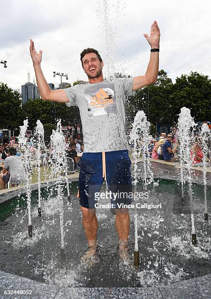 Mischa Zverev of Germany cools off in the water fountain in garden square during day eight of the 2017 Australian Open at Melbourne Park on January...